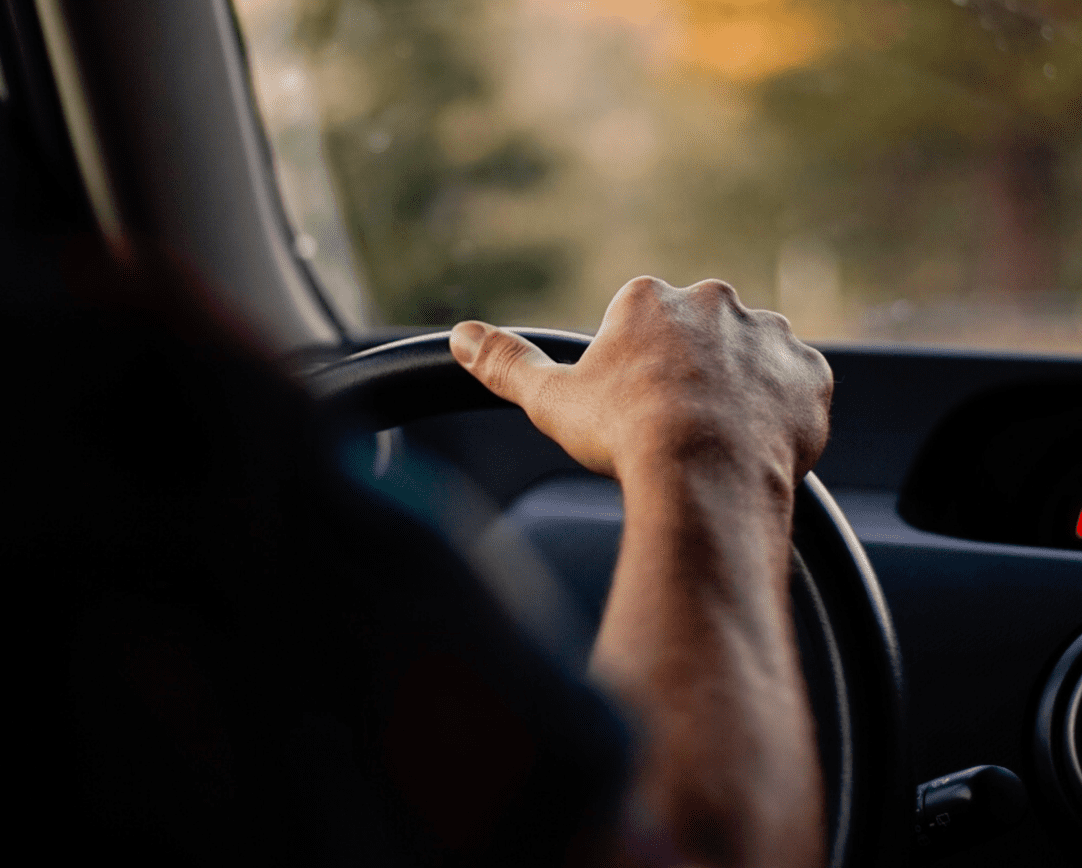 Close-up of hands on steering wheel