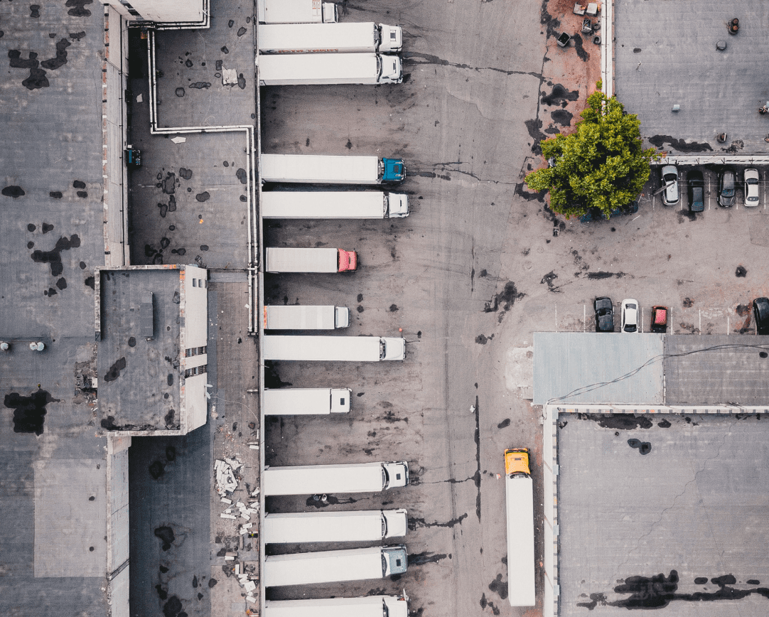 Aerial shot of trucks lined up in warehouse parking lot