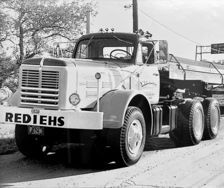 Black-and-white photo of Rediehs flatbed with cargo